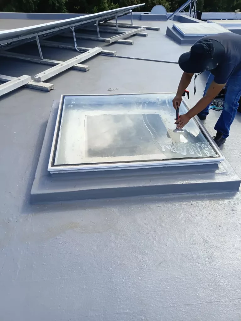 Old window tint removal from roof skylight using scraper during professional glass restoration