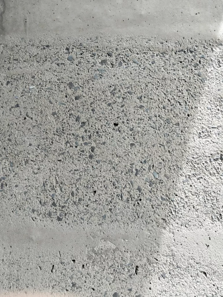 Sandblasted concrete surface exposing natural aggregate for architectural finish